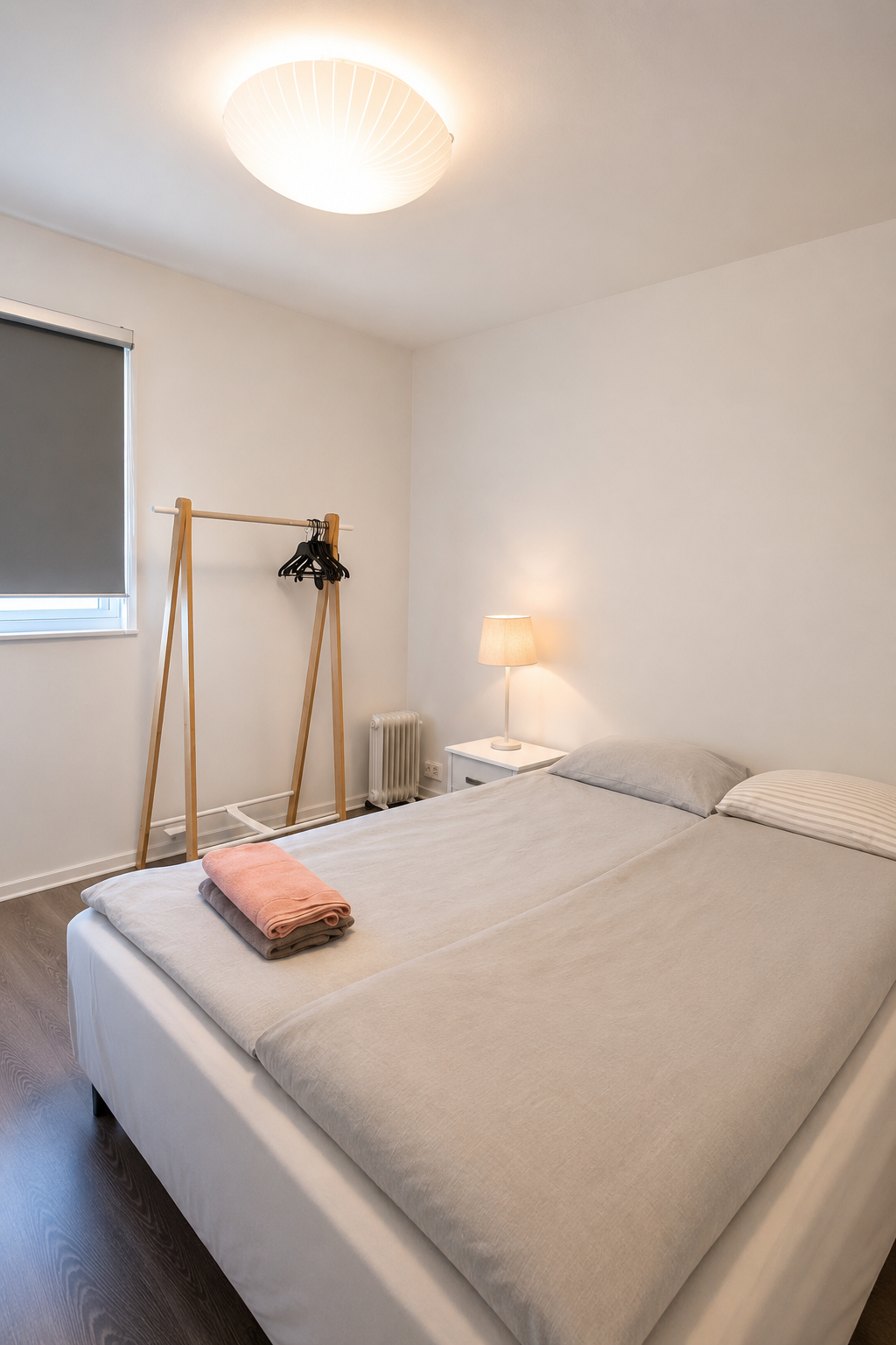 Schous bedroom with bed and clothes rail